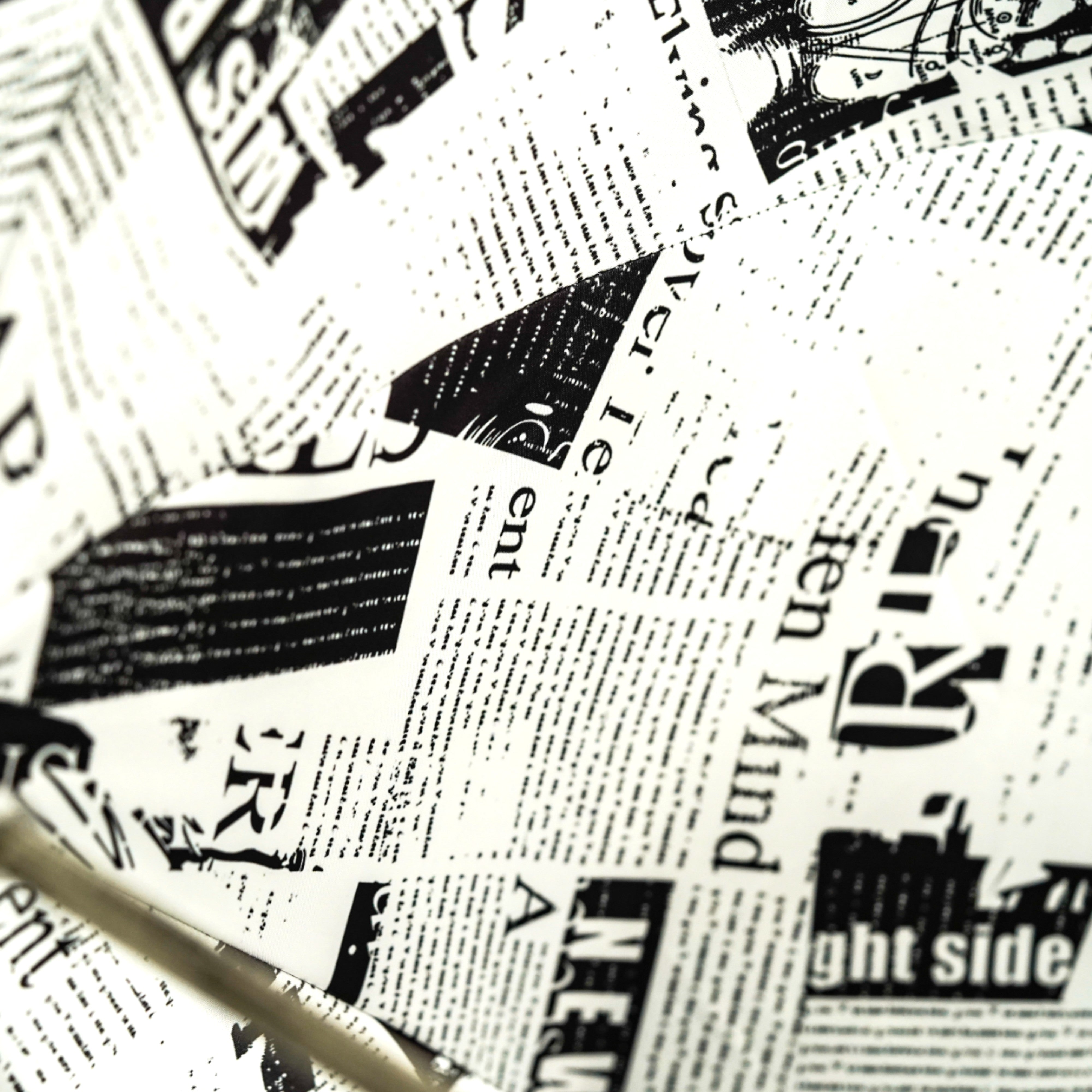 Read Between the Raindrops – The Newsprint Umbrella
