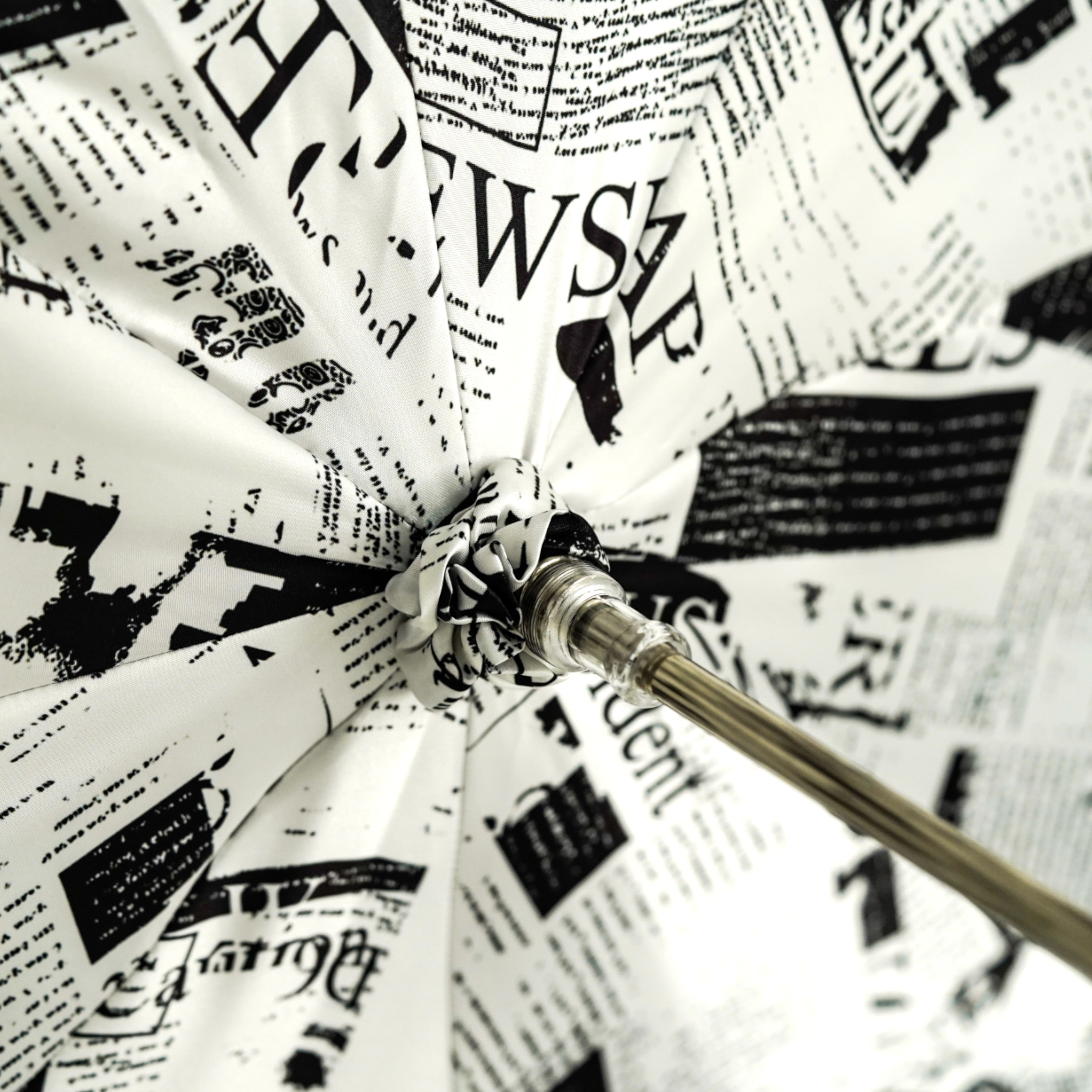 Read Between the Raindrops – The Newsprint Umbrella