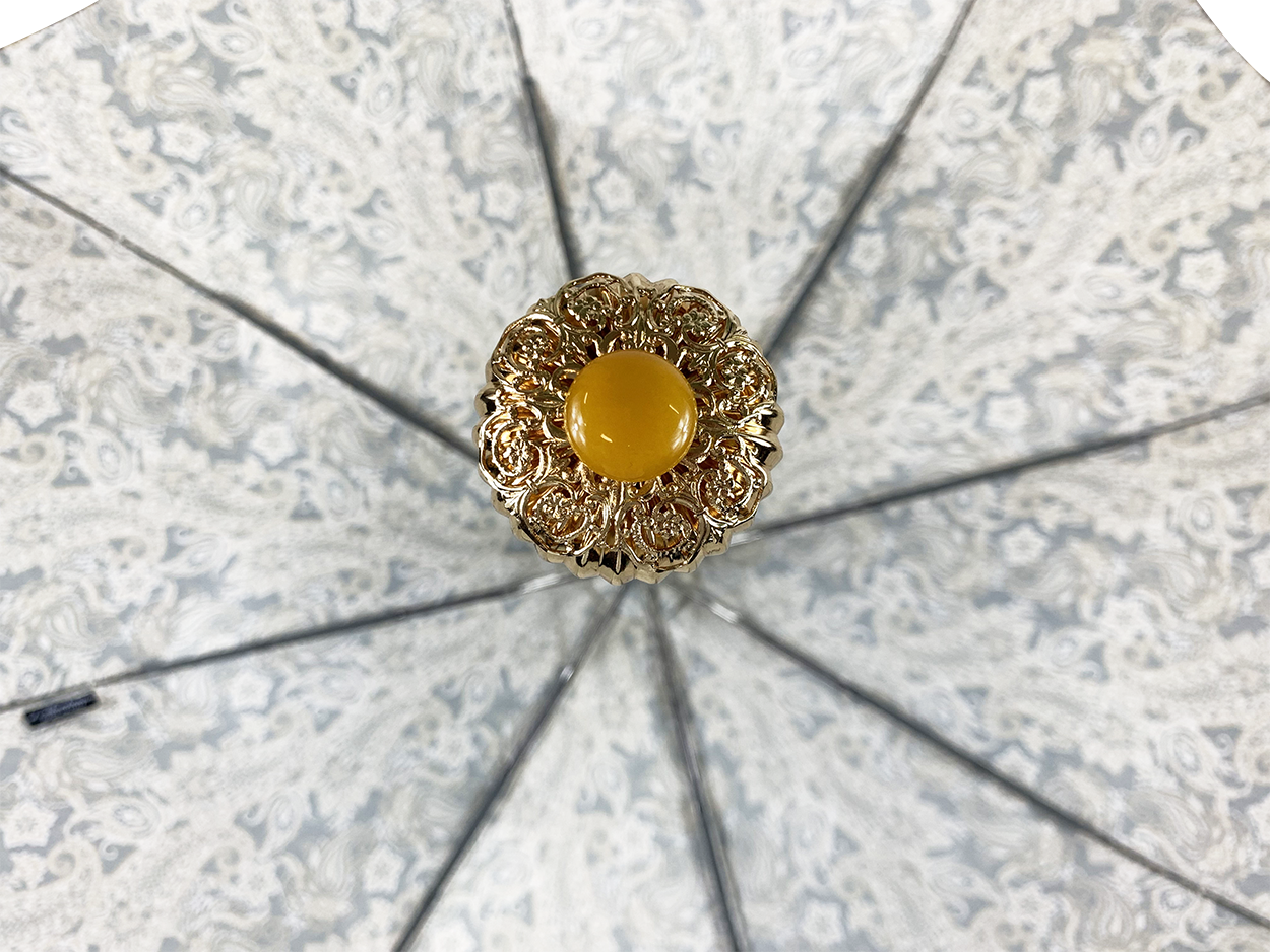 Cream paisley design with yellow stone
